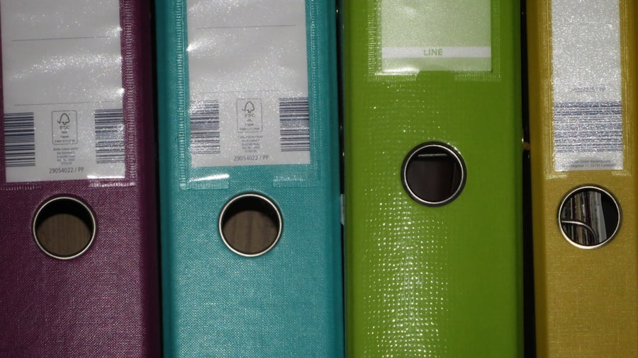 A row of colored binders on a shelf